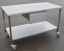 1 x Stainless Steel Prep Bench With Undershelf, Castor Wheels and Central Drawer - H87 x W140 x D7