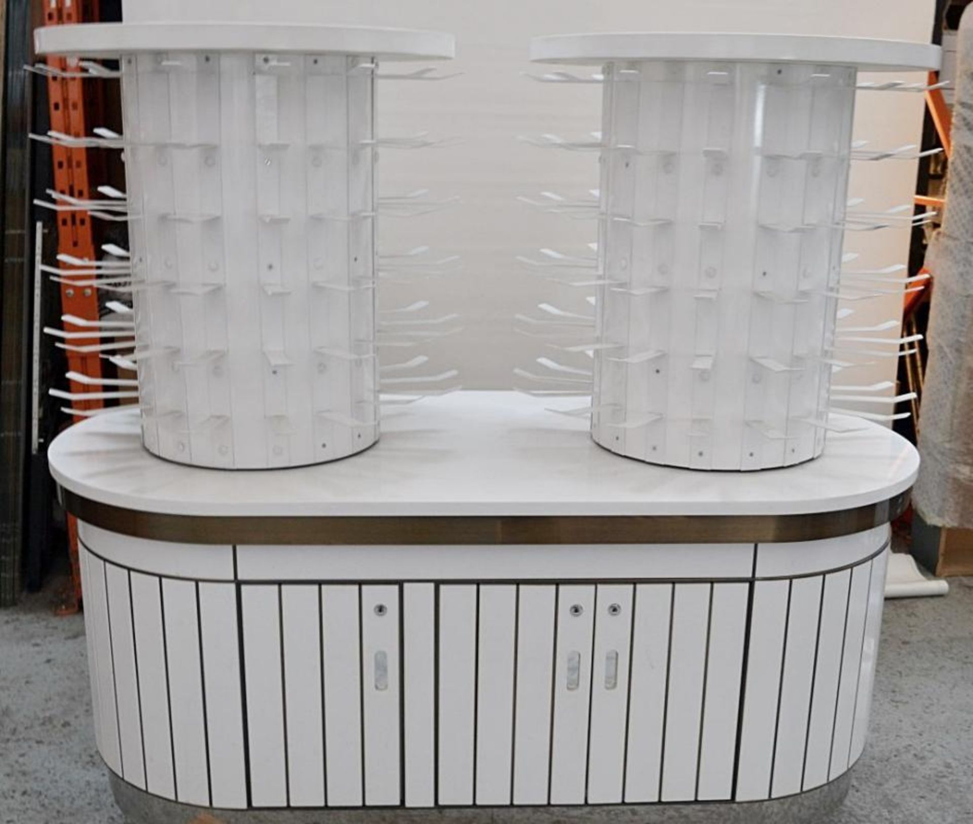A Pair Of Curved Cosmetics Shop Counters With Revolving Carousels In White - Recently Removed From H