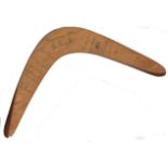 AUSTRALIAN CRICKET: A wooden boomerang featuring a kangaroo signed to the verso by twelve members