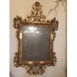 CARVED AND GILDED WOODEN MIRROR, GOLD GOUACHE GILDING, FIRST HALF OF 19TH CENTURY