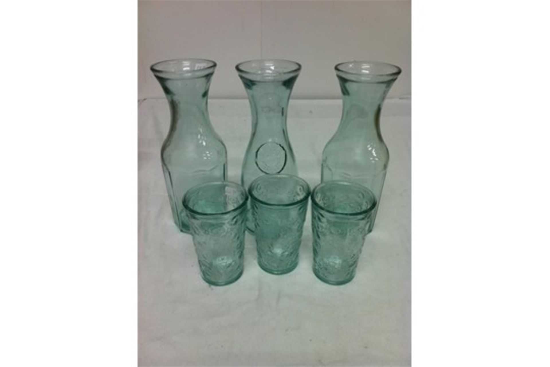 Quantity of 100% recycled glassware; 5 carafes/3 bottles with ceramic tops/4 storage jars/3 candle v