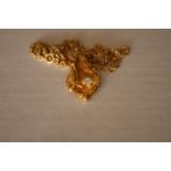 Collier en or avec pendentif en forme de pépite d'or serti d'un diamant blanc - [...]
