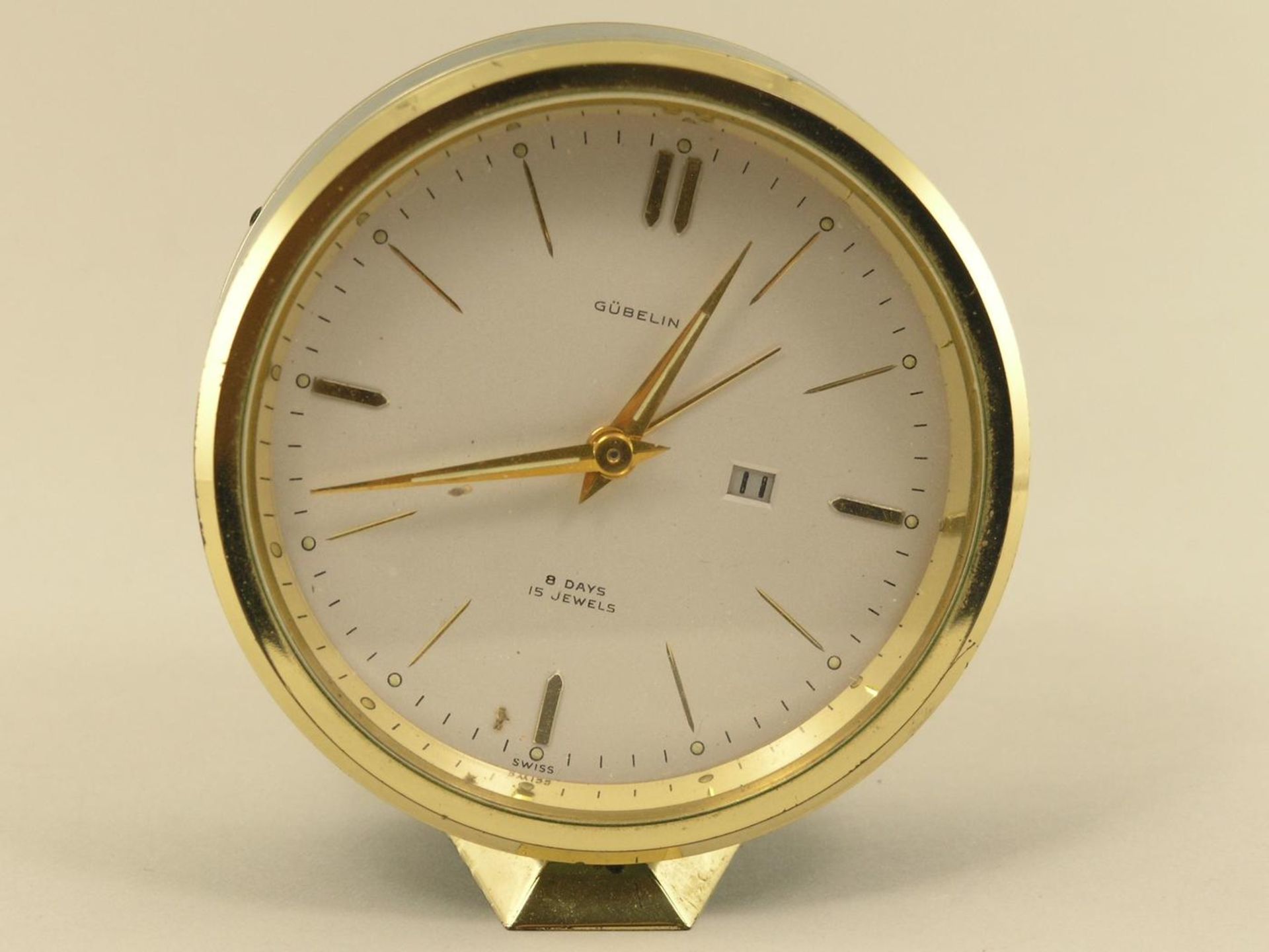 Tischuhr/Wecker: 8-Tage-Uhr mit Datum und Wecker, Gübelin 60er Jahre Ca. 8,5cm hoch, Messing