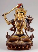 Bodhisattva ManjushriBronze, vergoldet. H. 20 cm. In seiner einen Hand hält er das flammende