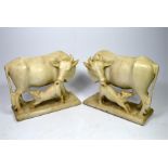 A pair of Indian marble figure groups, carved as cows suckling calves