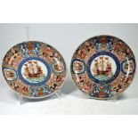 A pair of Japanese Imari ‘Black Ship’ dishes. painted with panels of Dutch merchants and ships