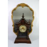 An American style clock and a gilt framed mirror, circa 1930