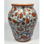 An Italian faience vase, decorated with foliage