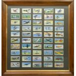 A framed set of 50 Players cigarette cards featuring 20th century aircraft