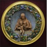 A Della Robbia plaque in a glass case,