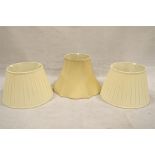 Three cream coloured silk lampshades,