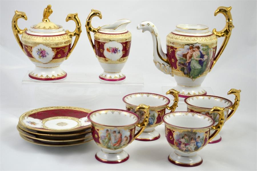 A Vienna porcelain tea set with floral decoration, including a teapot, sugar bowl, and milk jug