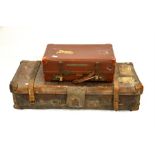 Two vintage suitcases, one leather.