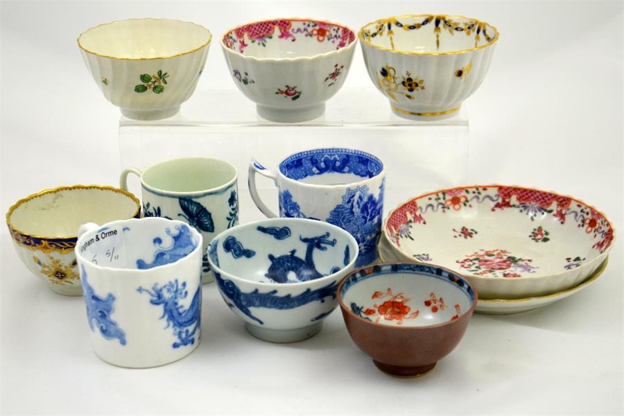 A collection of tea bowls, cups and two saucers