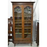 An arts and crafts oak bookcase cabinet, with Mackintosh style leaded and stained glass