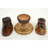 Two Doulton Lambeth stoneware Triumph patent inkwell and pen rests