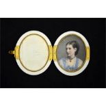 A late 19th century ivory locket with miniature of a lady on the inside