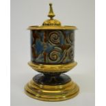 A Doulton stoneware brass mounted pedestal vessel and cover