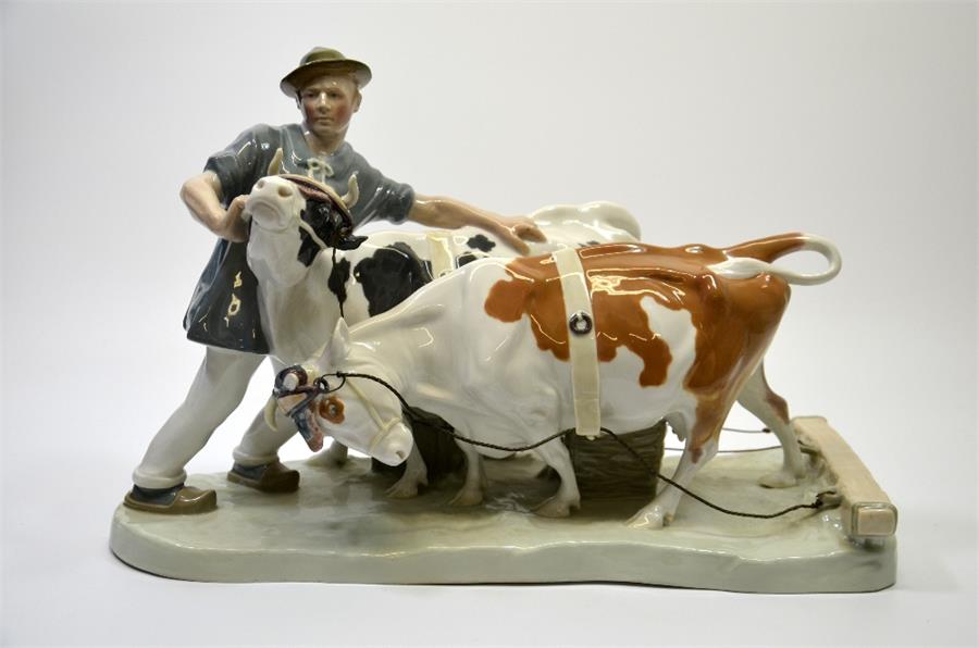 A Meissen group of a farmer with two cattle