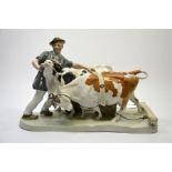 A Meissen group of a farmer with two cattle