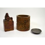 A Chinese bamboo brush pot, a Chinese carved wood stand and a Chinese carved soapstone