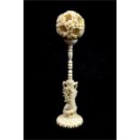 λ A Chinese carved ivory puzzle ball on stand