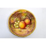 A Royal Worcester fruit decorated,rope edged, tea plate