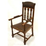A large arts and crafts oak library/gentleman's carved chair with original tooled leather