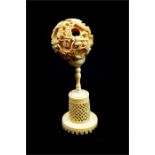 λ A Chinese carved ivory puzzle ball on stand