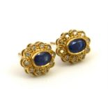 A pair of oval sapphire and diamond earrings