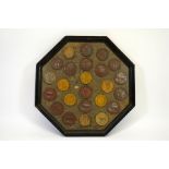 A framed marble plaque with a collection of bronze dairy medals