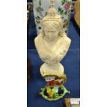 A stone bust of Queen Victoria and a porcelain butterfly figure