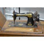 A treddle operated Singer sewing machine in wooden casing