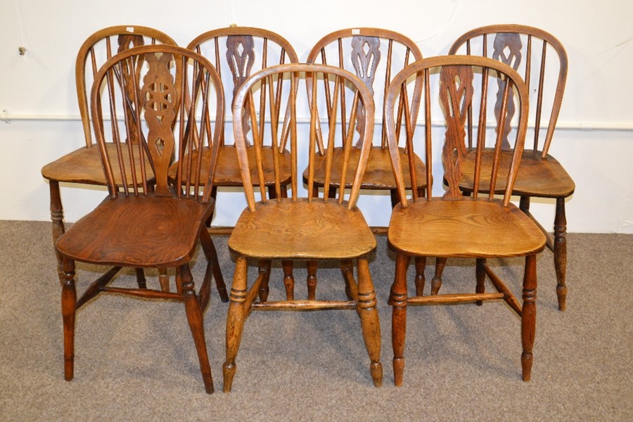 Seven matched elm seated Windsor chairs