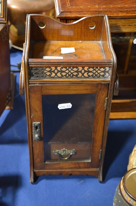 A glass fronted wooden chest
