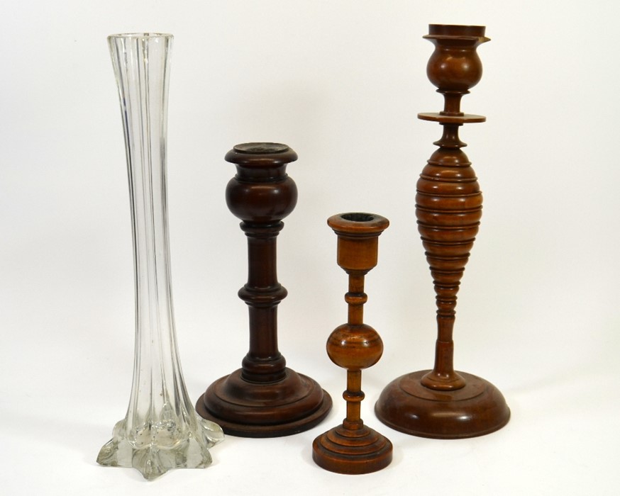 A collection of wooden candlesticks and a glass spill vase, tallest 41cm. (4)