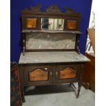 A wooden sideboard with granite top and back