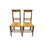 A pair of Arts and Crafts oak chairs