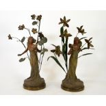 A pair of French Art Nouveau bronzed and painted figures, La Violette and L'Orchidee