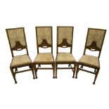 A set of four Arts and Crafts oak dining chairs