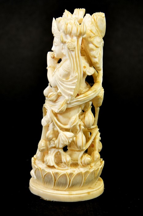 λ A 19th century Indian carved ivory figure of a deity playing the pipe - Image 2 of 6