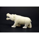 λ A 19th century African carved ivory figure of a hippo