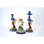 Three majolica candlesticks, including a pair of Minton figural candlesticks, 1855