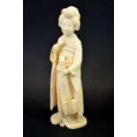 λ A 19th century Japanese carved ivory okimono of a Geisha, Meiji,