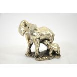 An Elizabeth II silver foil encased resin sculpture of an elephant and calf,