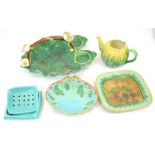 A collection of majolica including George Jones basket and butter stand, holly and berry dish etc.