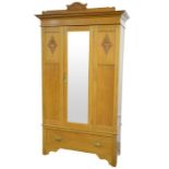 An Arts and Crafts light oak wardrobe