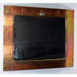 An Arts and Crafts Liberty-style copper framed rectangular mirror