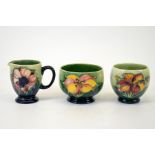 A group of three Moorcroft pieces, a clematis vase, a clematis bowl and an anemone jug,