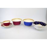 Two Rockingham slop bowls and a tea cup and saucer